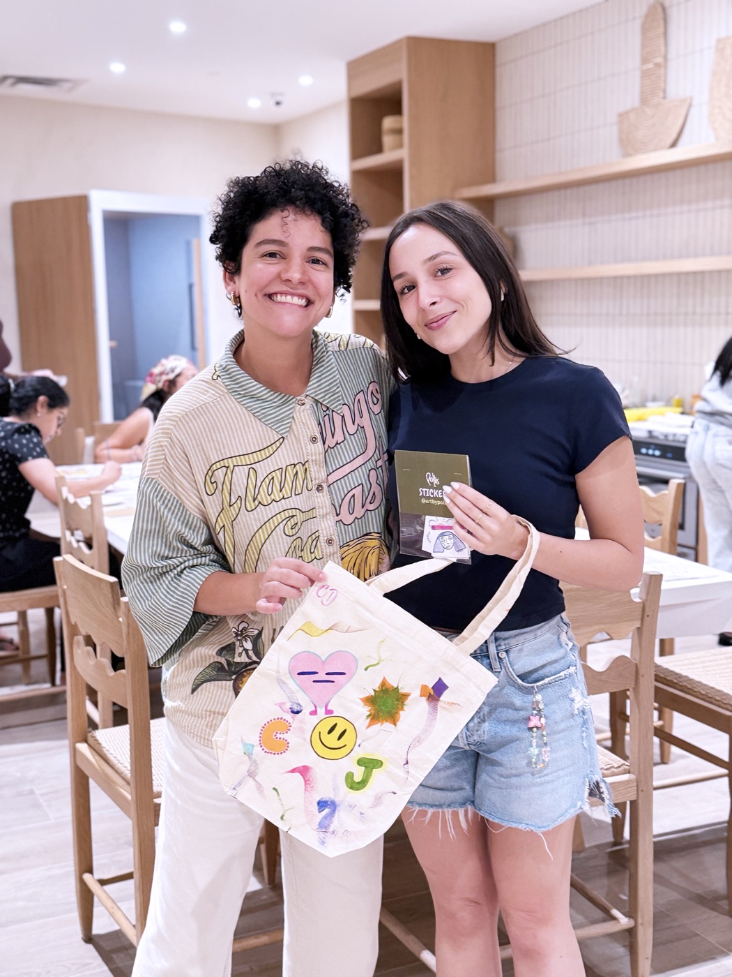 Participants showing their painted tote bags